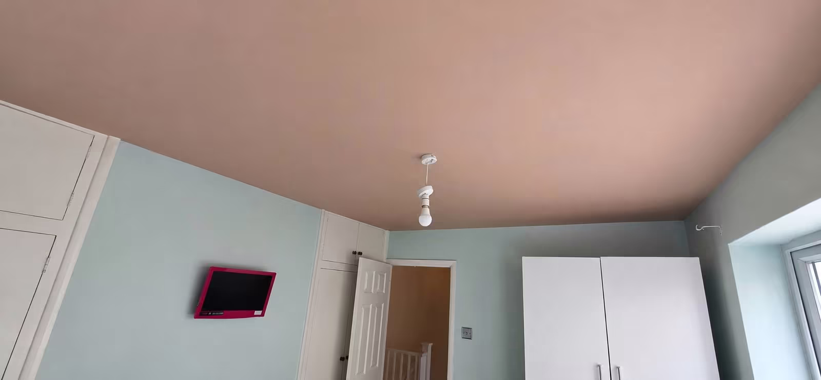 Freshly skimmed bedroom ceiling above painted sage walls
